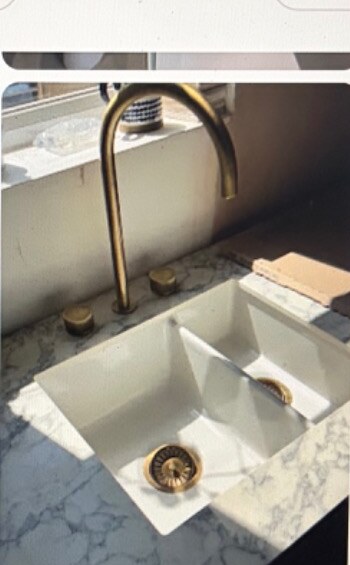 White sink with brass tap