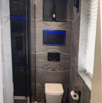 Dark tiled modern wet room